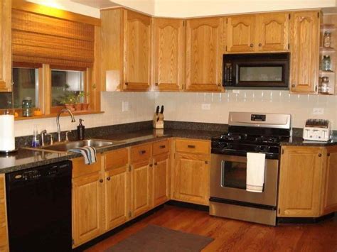 oak kitchen cabinets with black stainless steel appliances|updating honey oak cabinets.